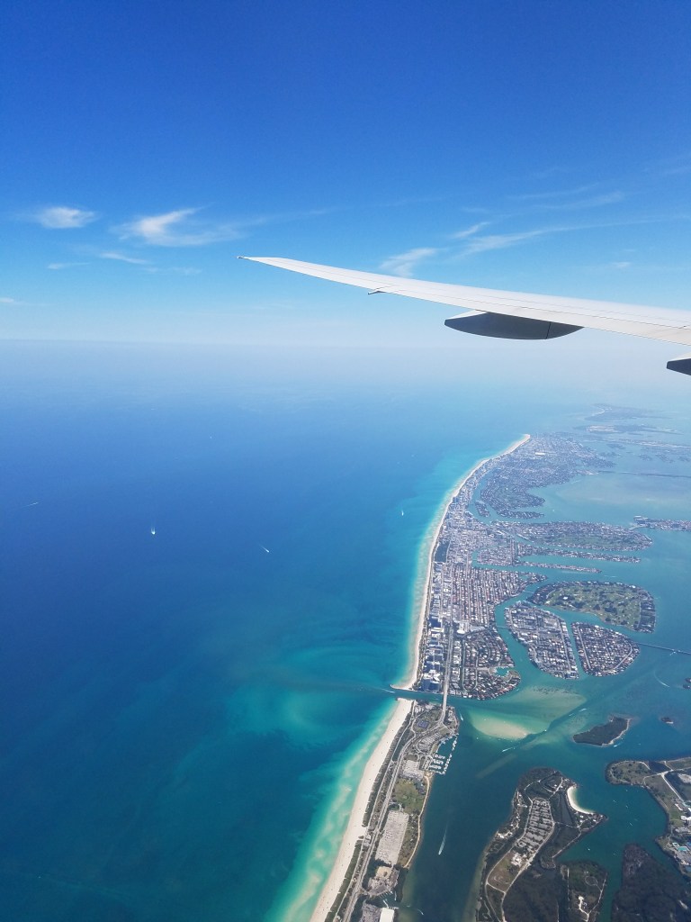 Wing of plane over Miami Florida