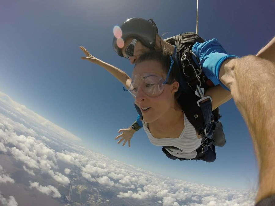 Woman tandem skydiving with an instructor