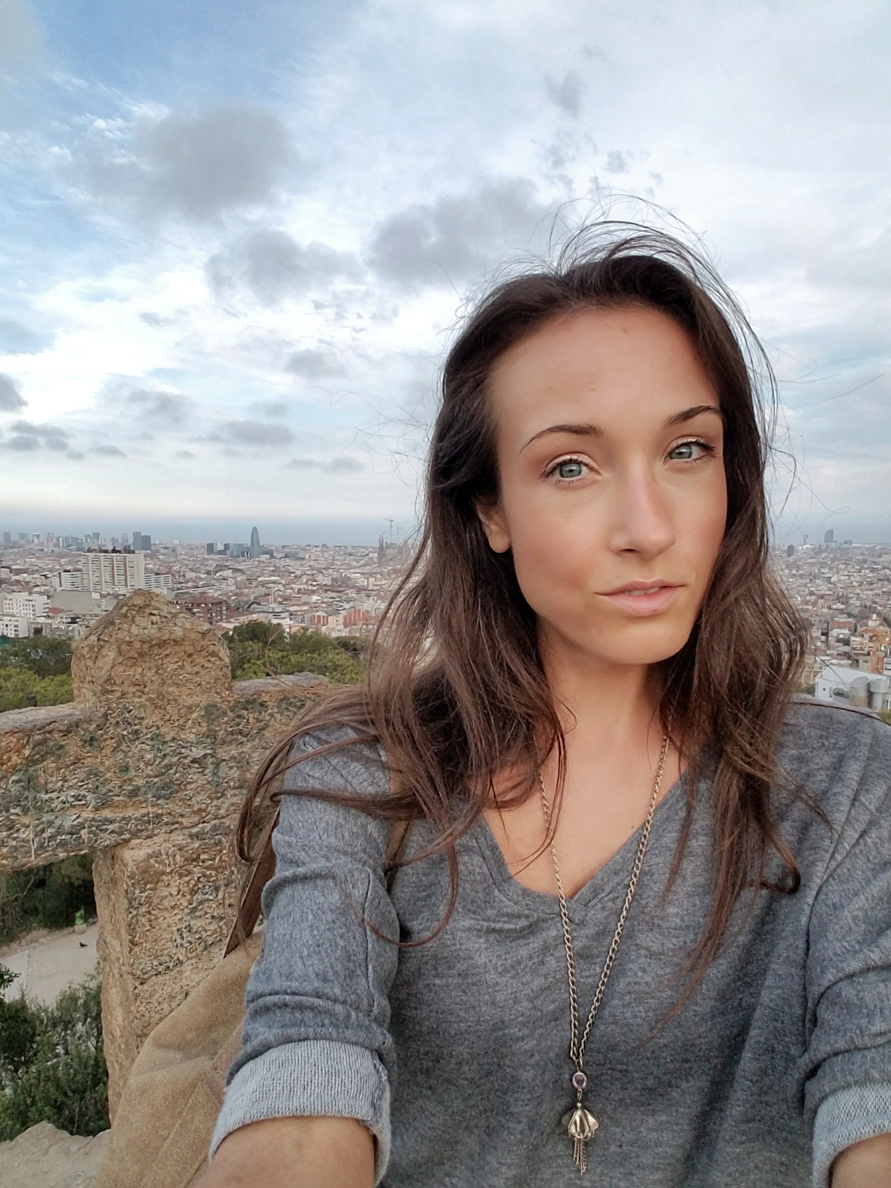 Woman taking a selfie with Barcelona Spain in the background