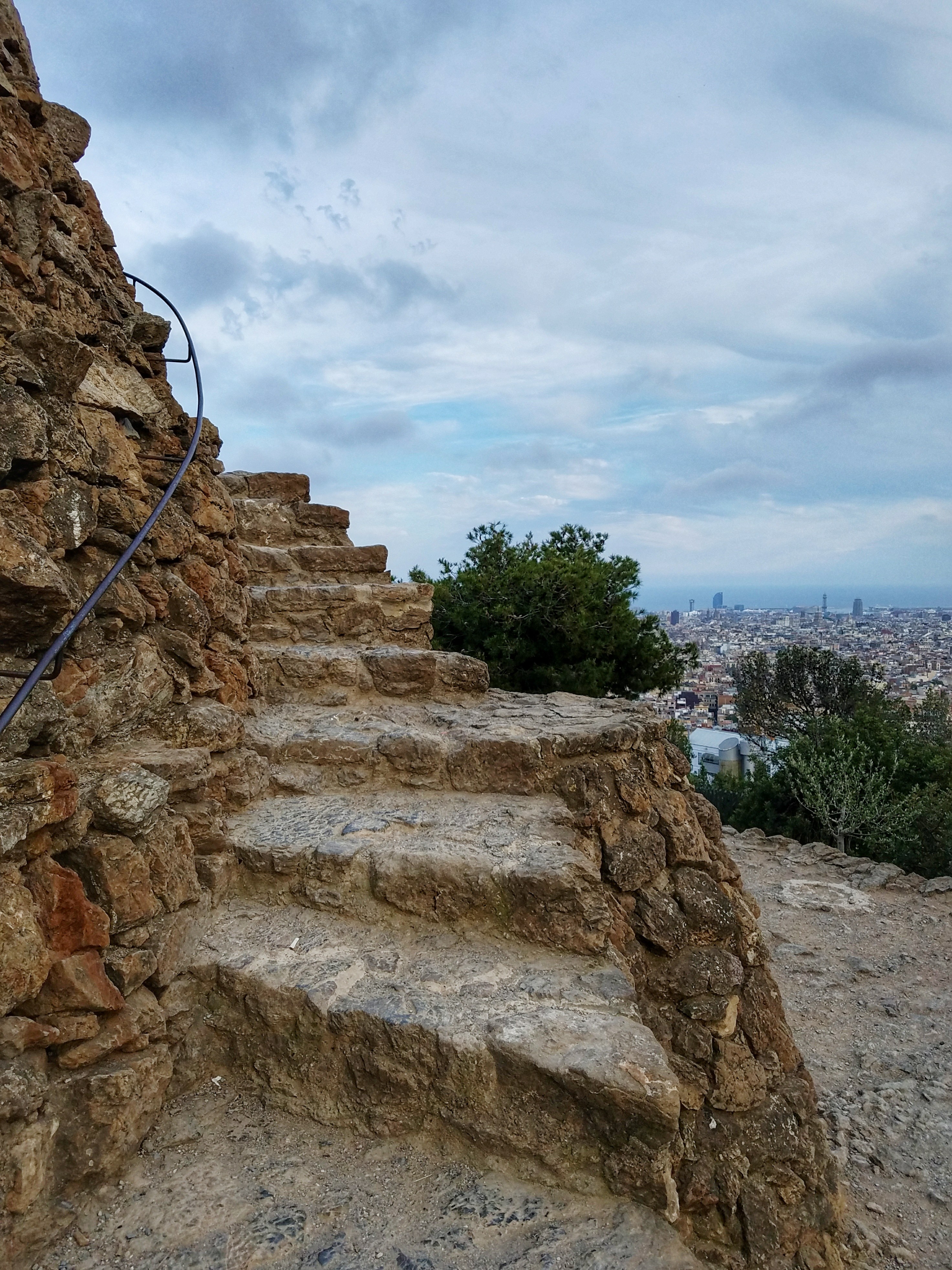 Stone stairway in Park Guell with Barcelona city views