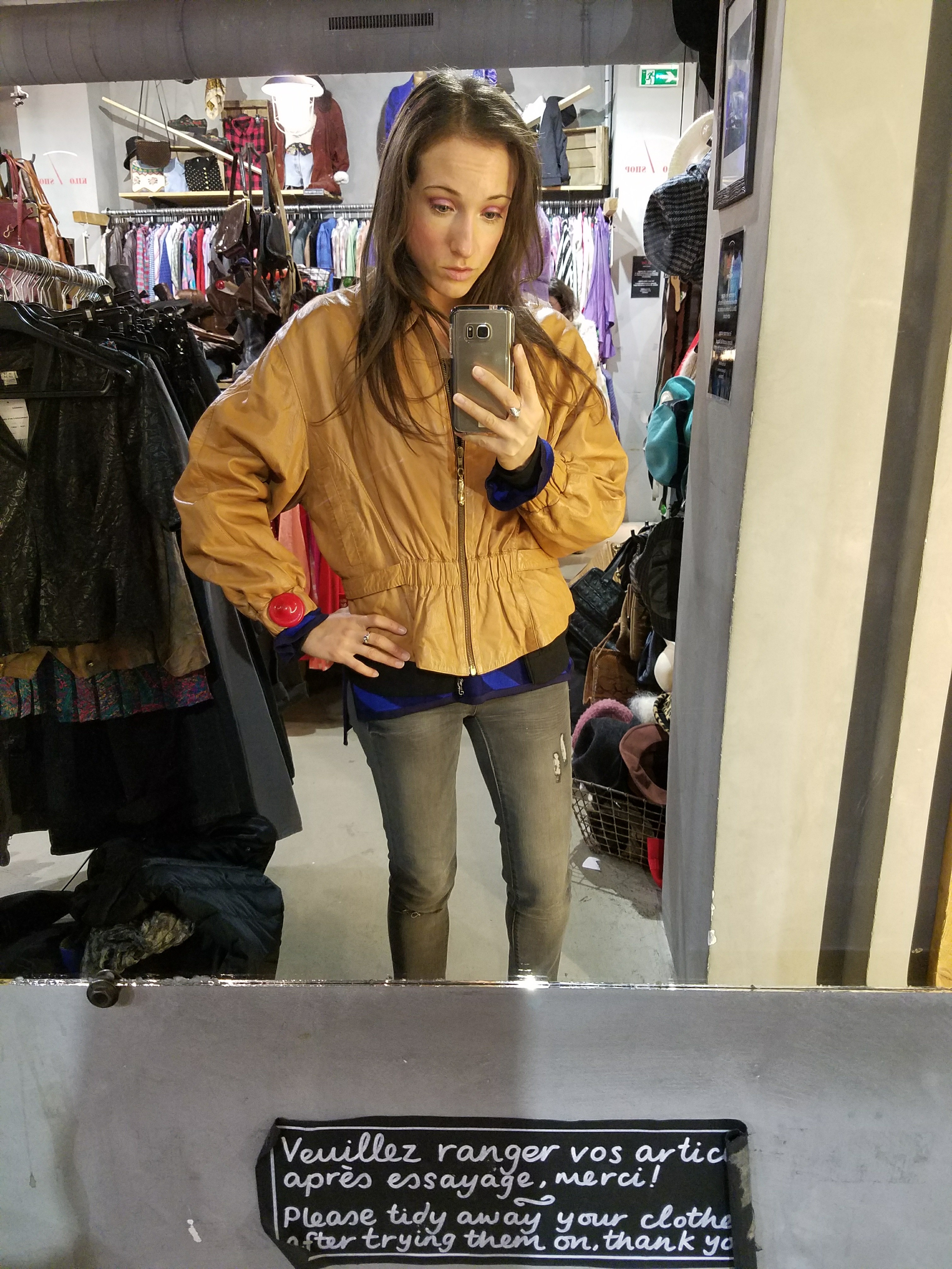 Woman trying on a jacket in a store