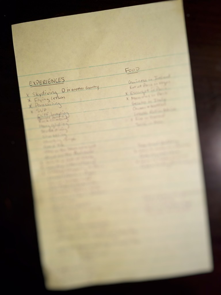 Handwritten bucket list on a notepad with lines