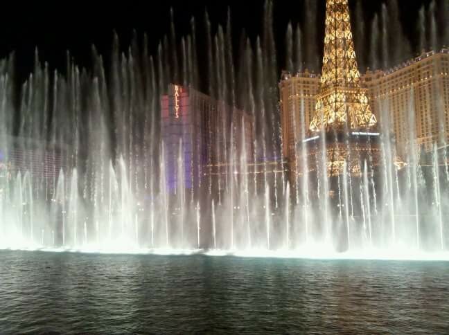 Bellagio Fountains in Las Vegas, Nevada with Paris Eiffel Tower Restaurant in view