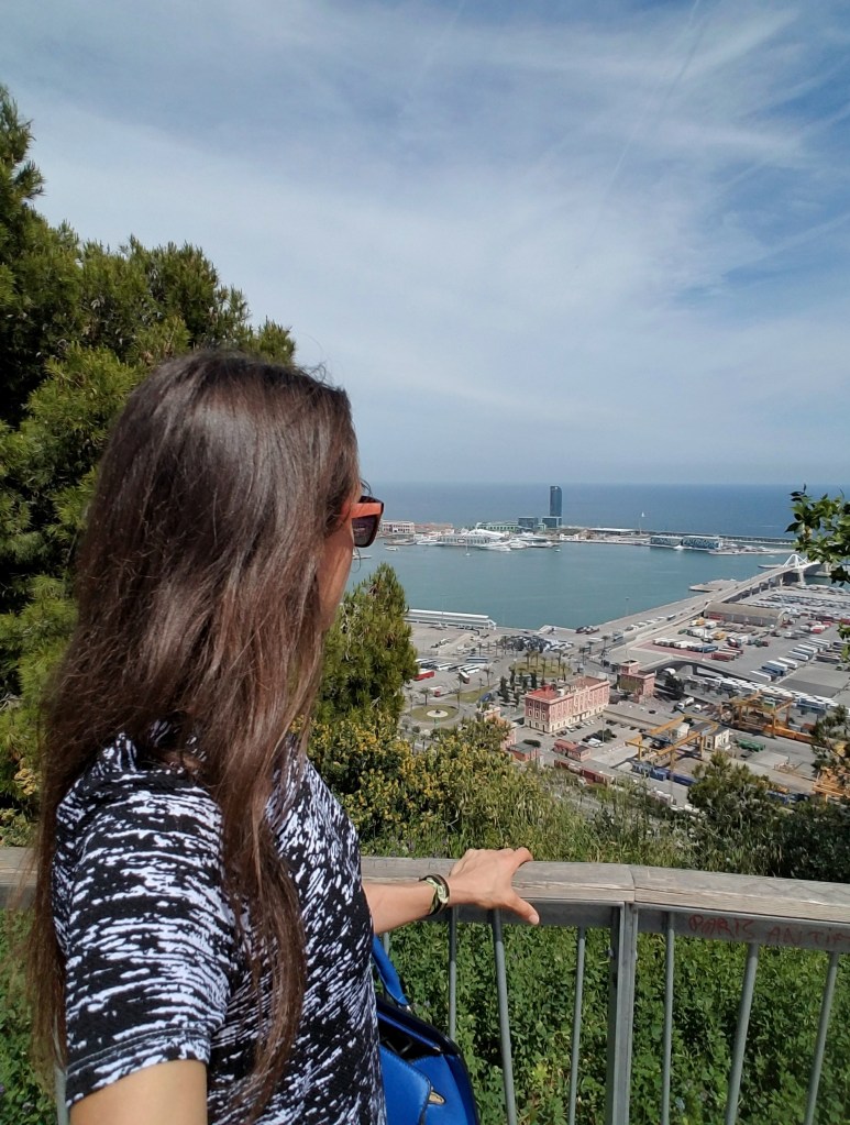 Woman wearing sunglasses looking out over a marina