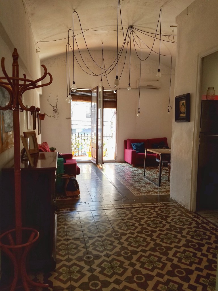 Apartment in Barcelona Spain with tile floor and lights hanging from celing