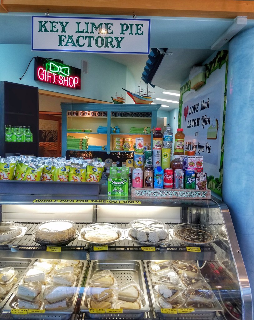 Whole pies and slices of pie in a case