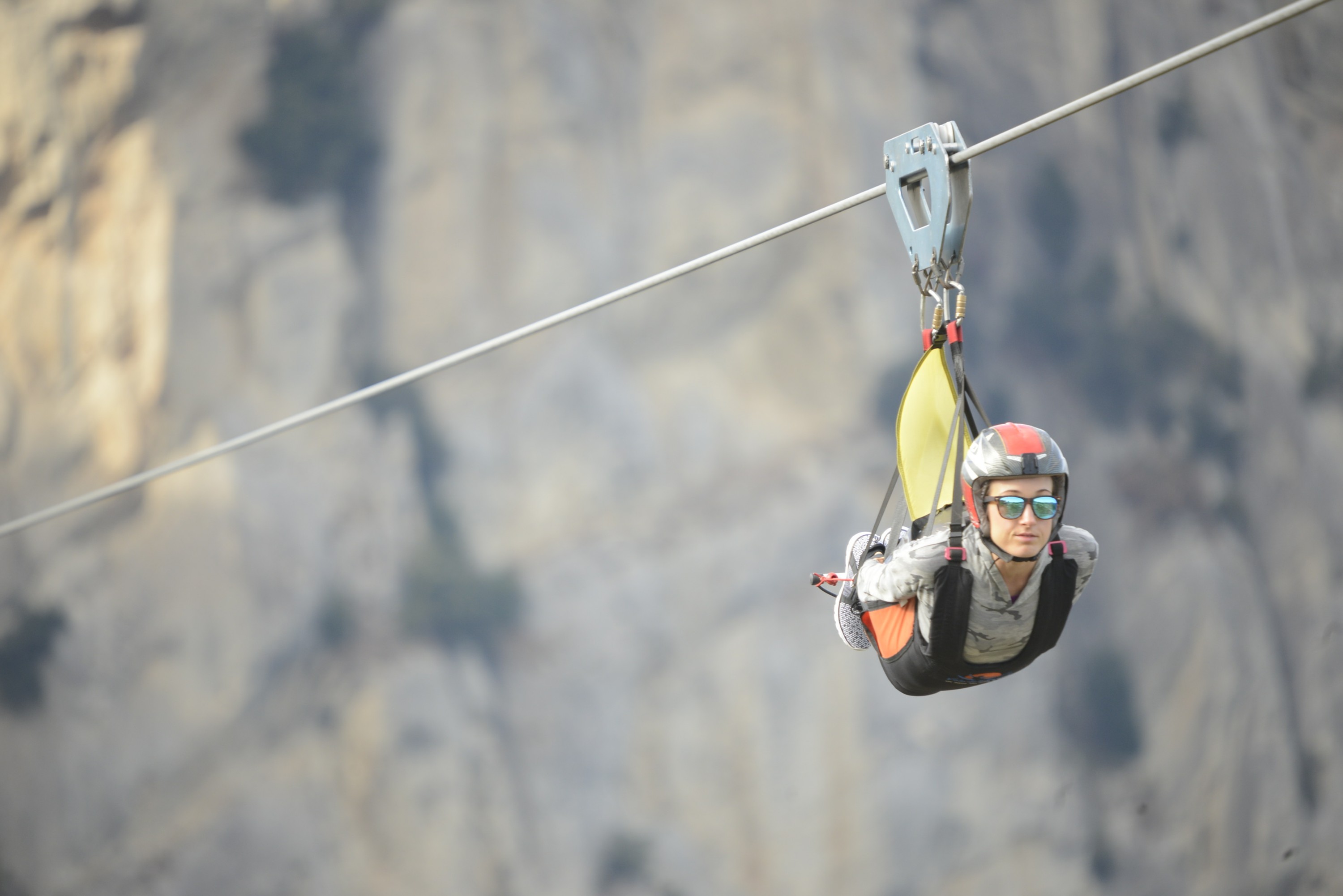 Woman ziplining with helmet
