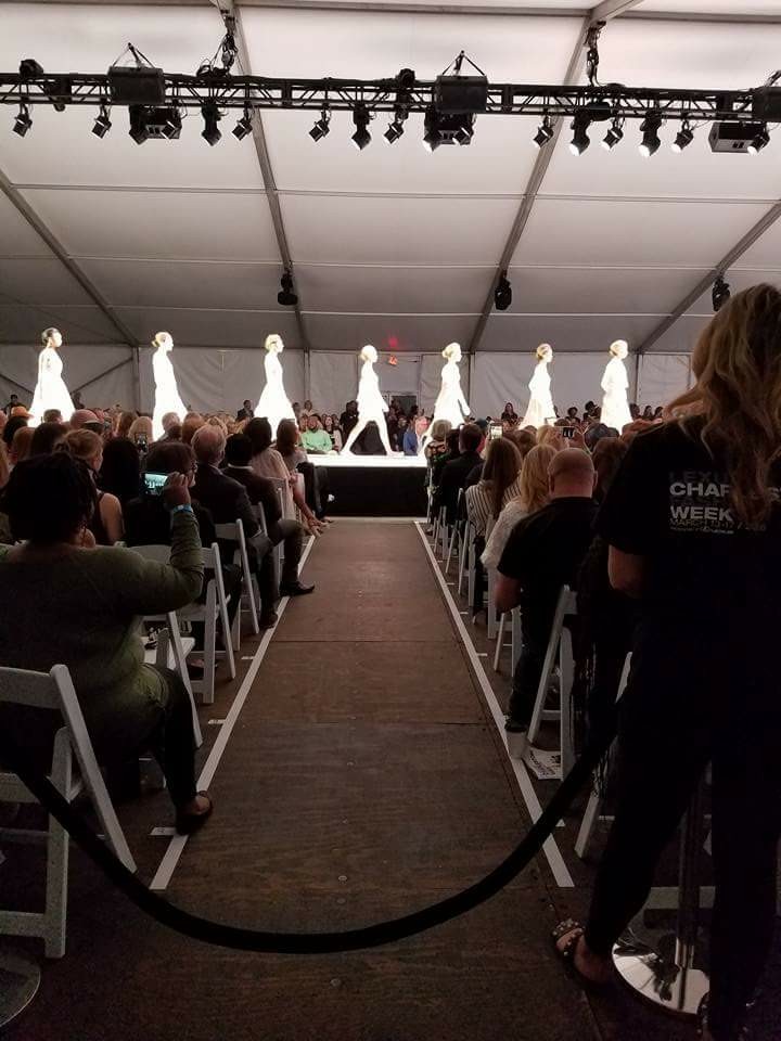 Fashion show runway with people seated