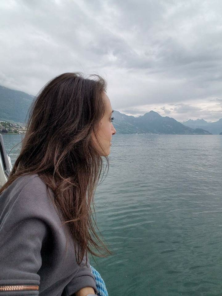 Woman looking out over a lake in the Swiss Alps