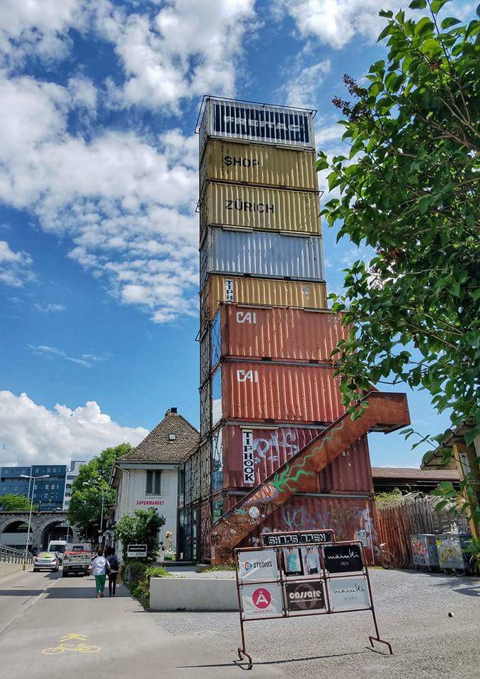 A tower of colorful shipping containers stacked on top of each other