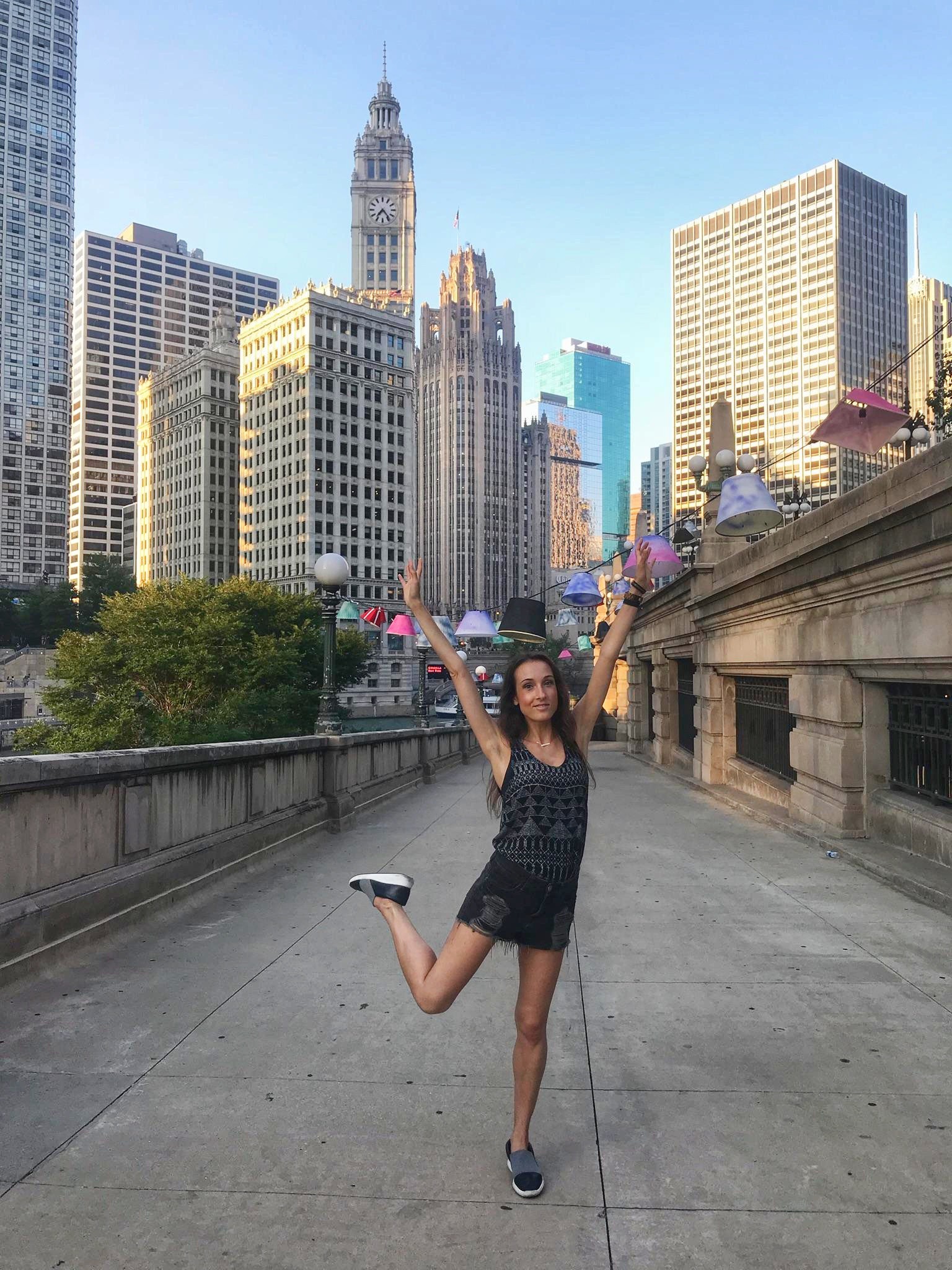 Woman with hands up on a sidewalk in Chicago