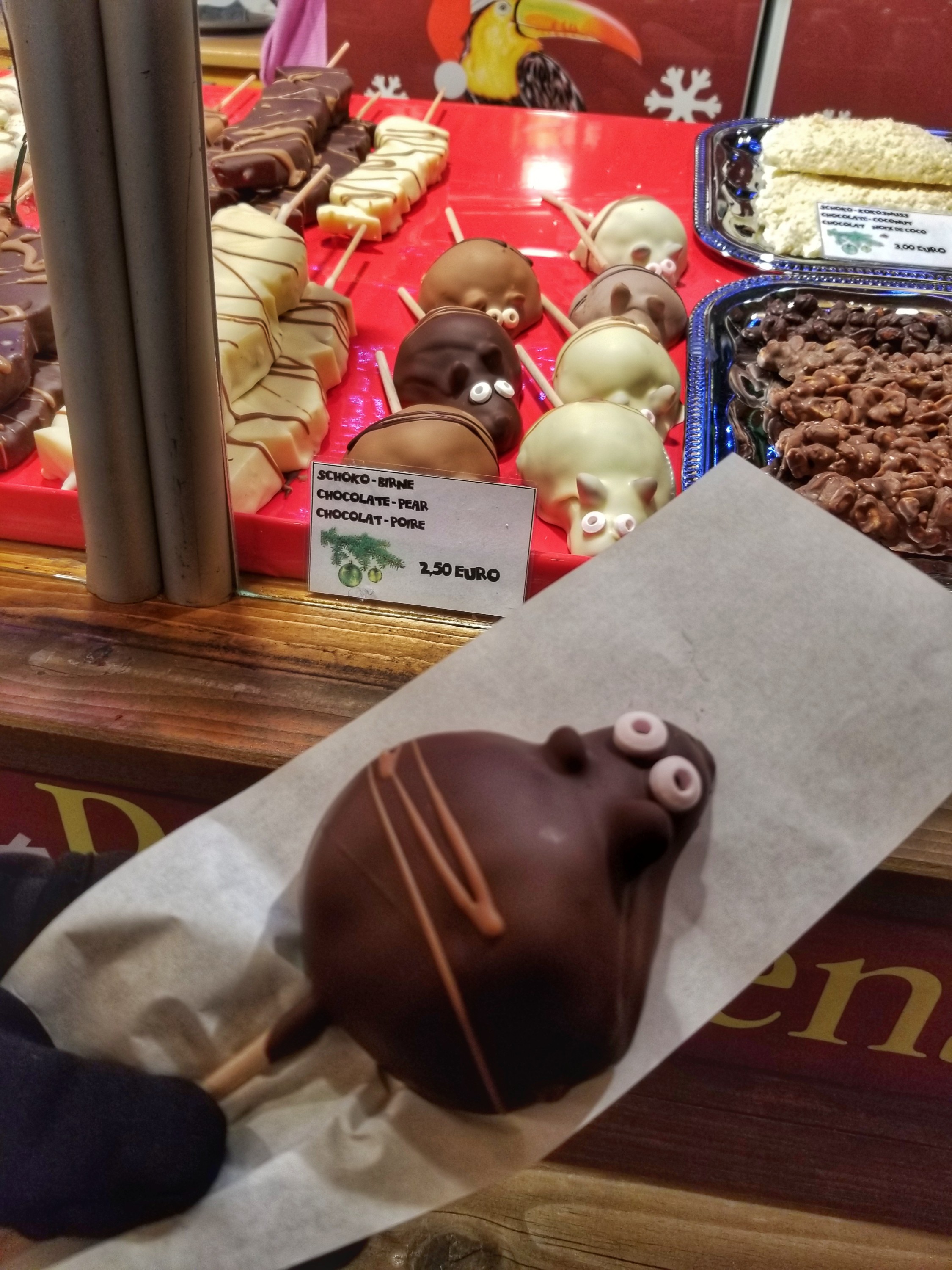 Display case of chocolate covered pears decorated like animals
