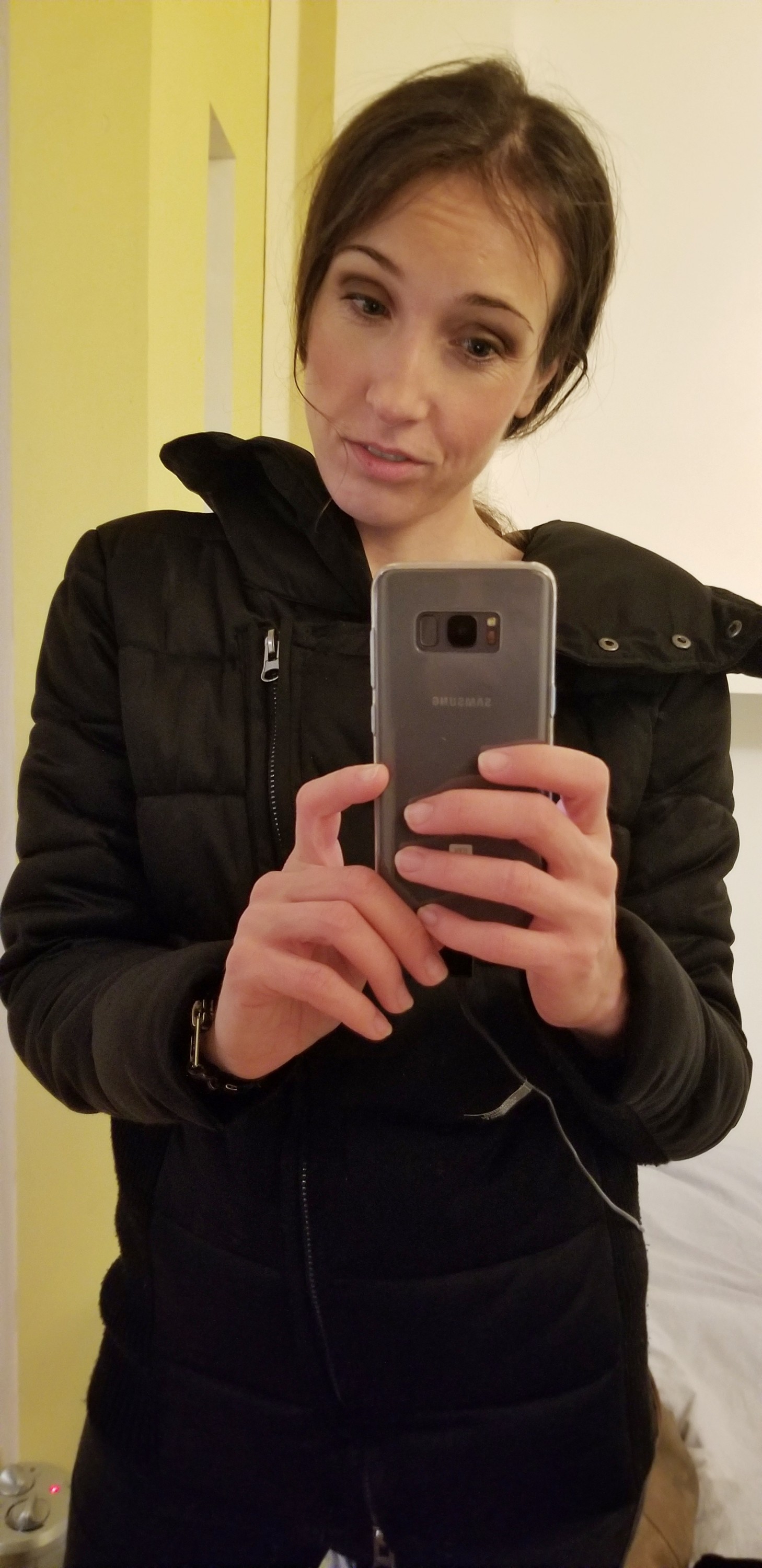Woman with hat hair, taking a selfie