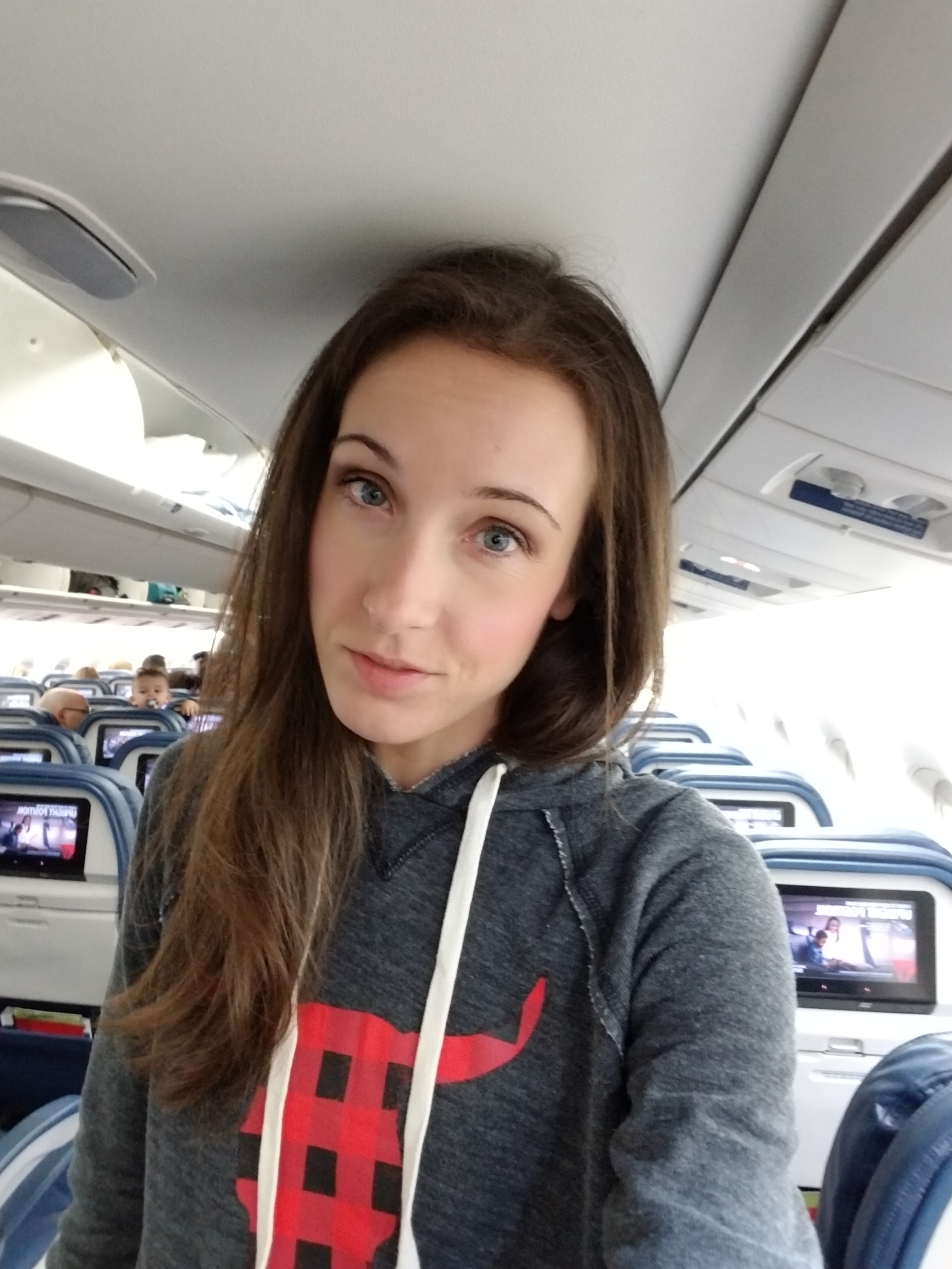 Woman taking a selfie on a plane