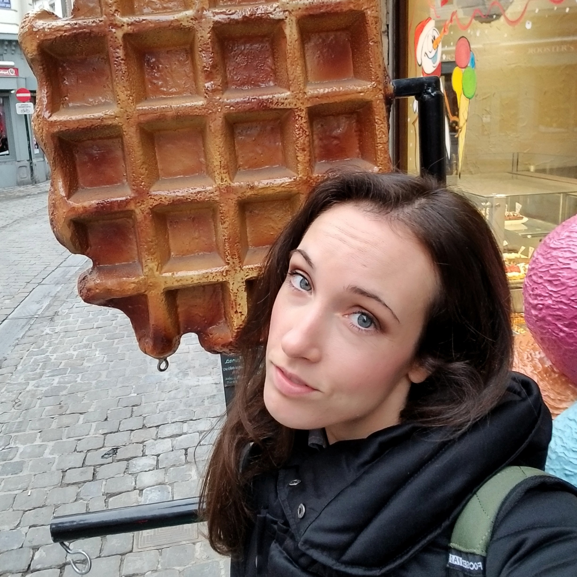 Woman posing next to a giant waffle statue