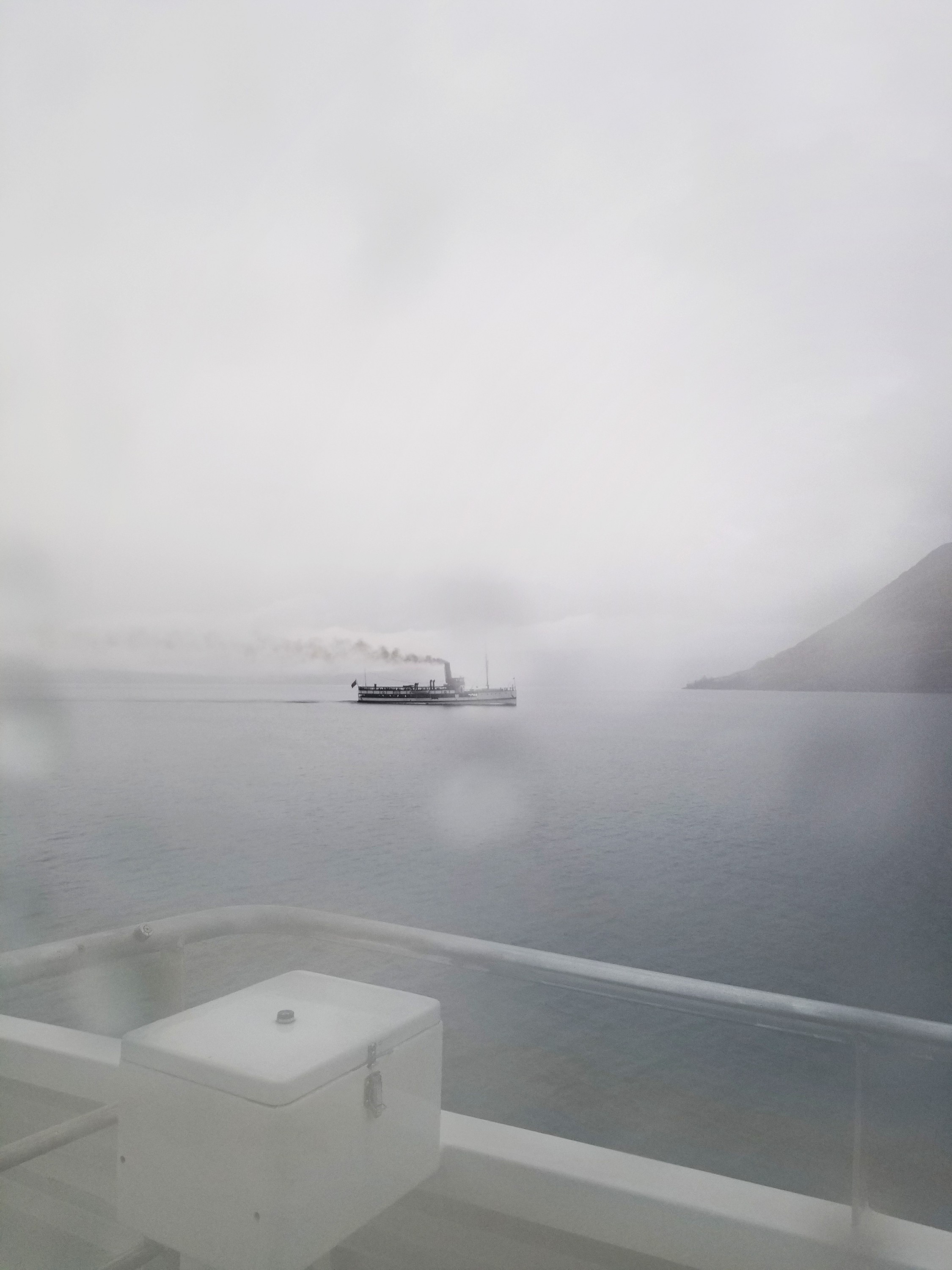 Old steamship in the fog on a lake