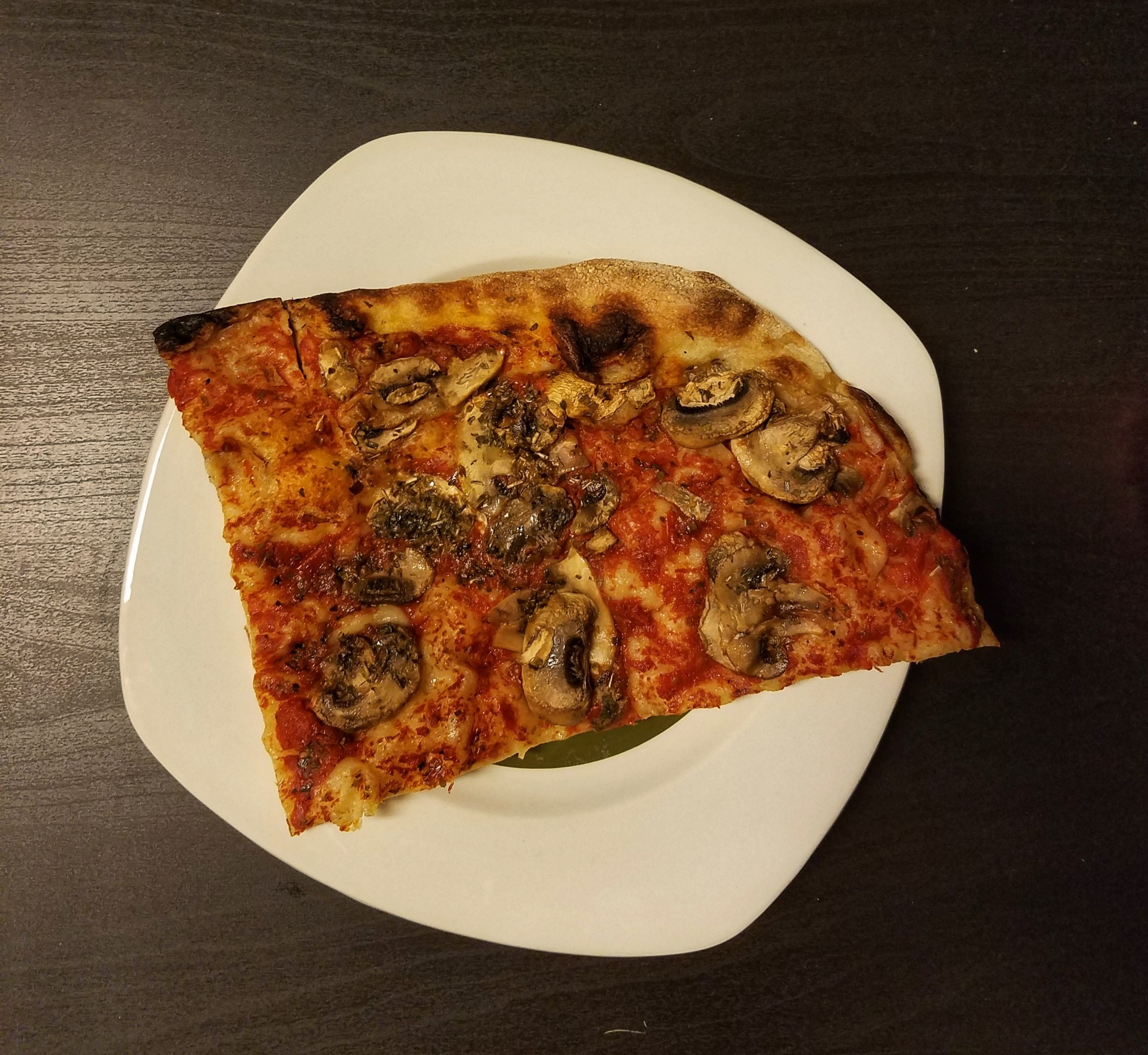 Piece of pizza on a white plate