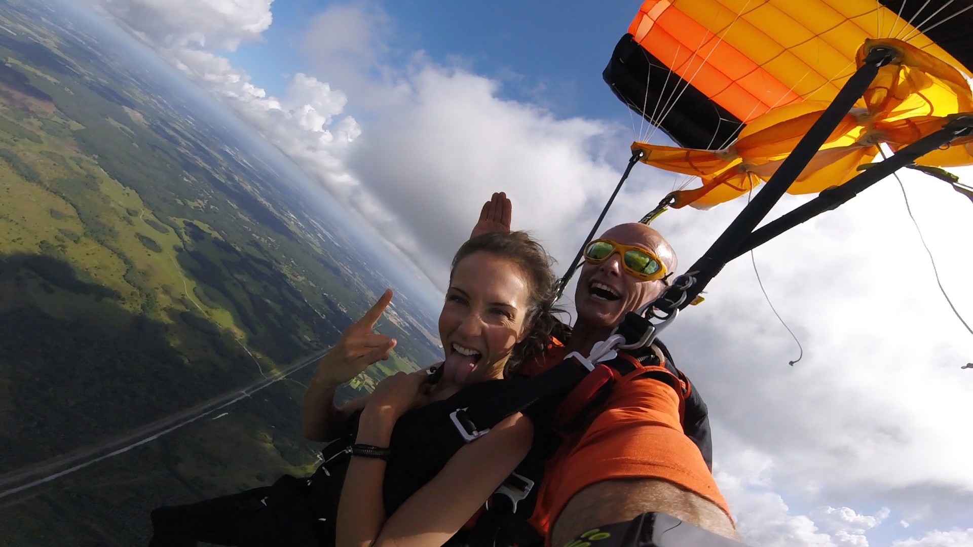 Woman and man tandem skydiving