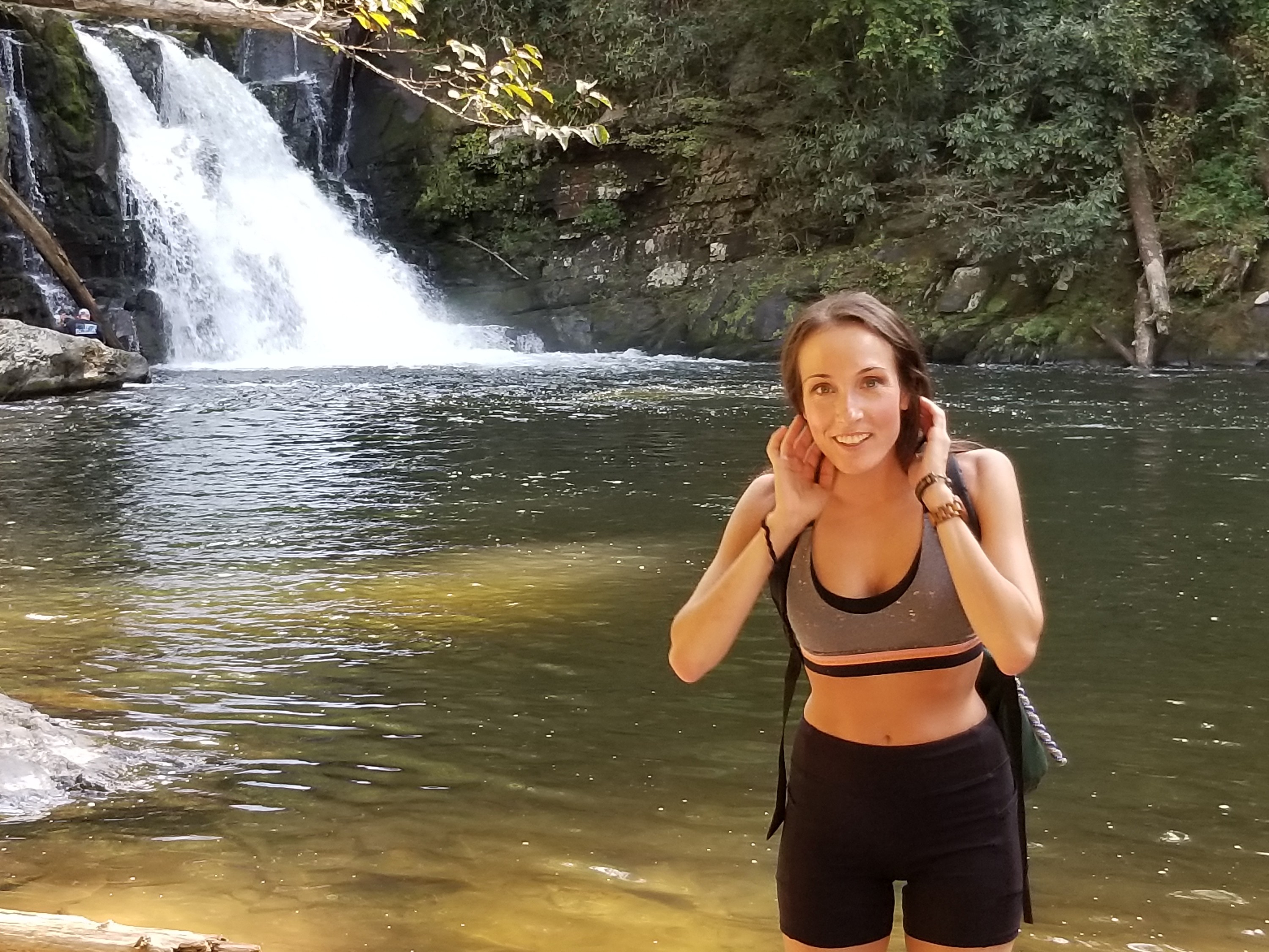 Woman in front of a waterfall