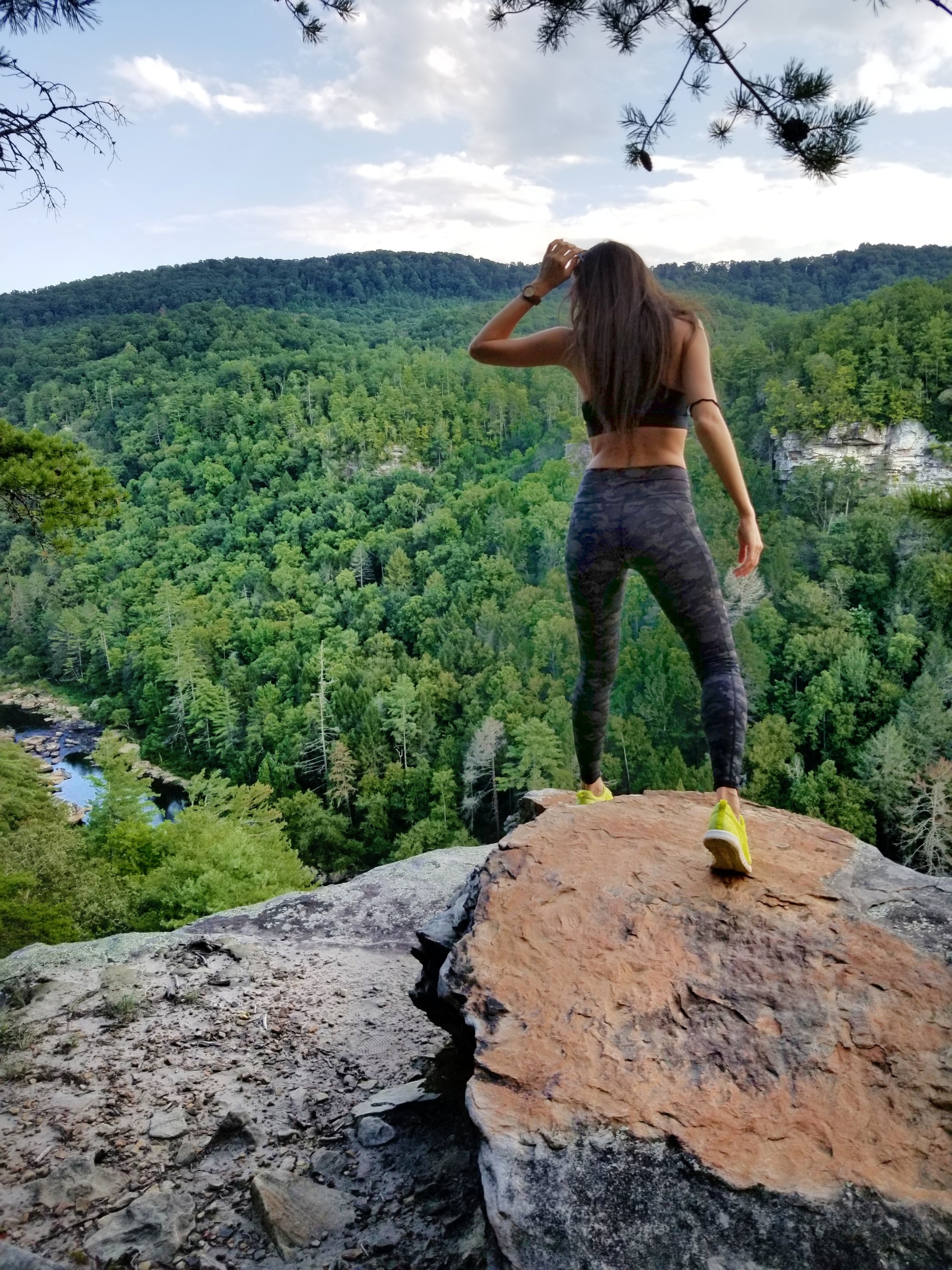 Woman looking over the edge of a cliff