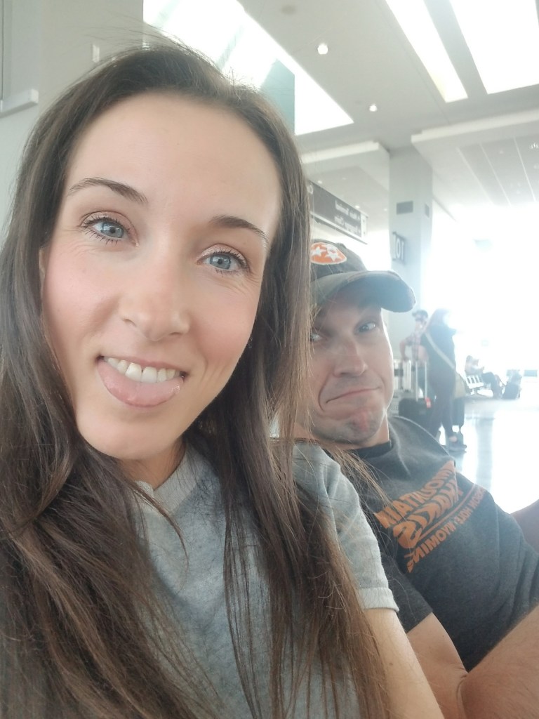 Woman and man taking a selfie in an airport