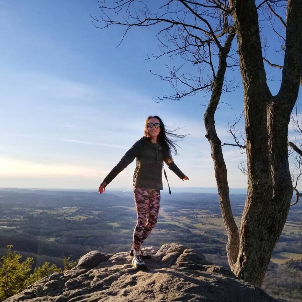Woman standing on the edge of a mountain