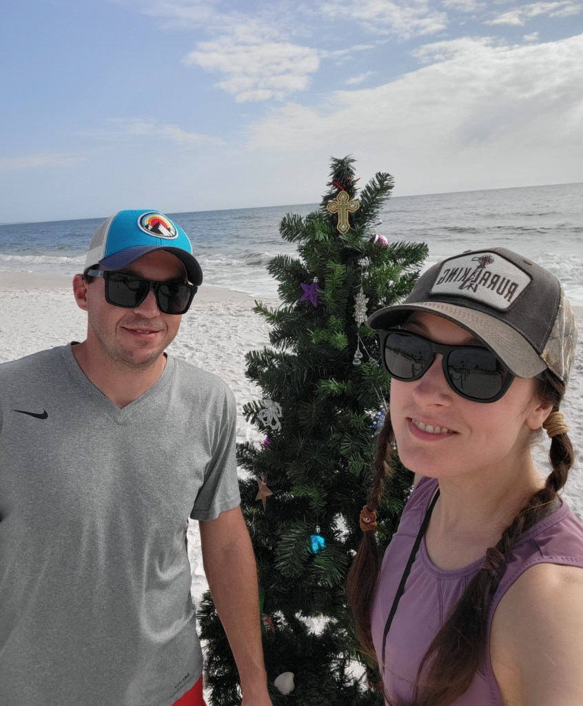 Couple with Christmas tree on a beach in Florida