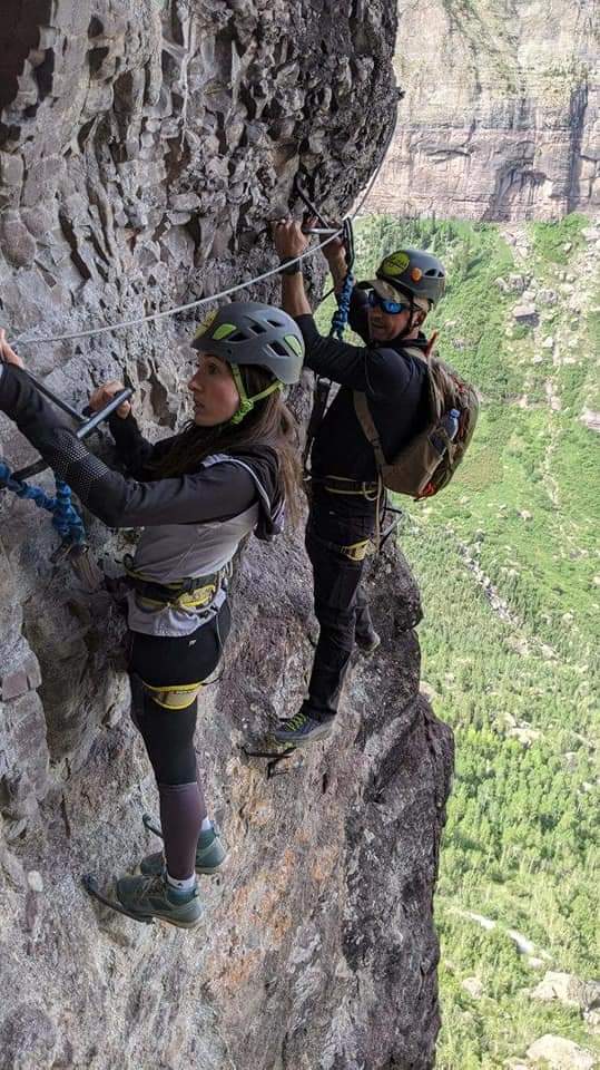 Woman and man completing via ferrata Telluride canyon Colorado