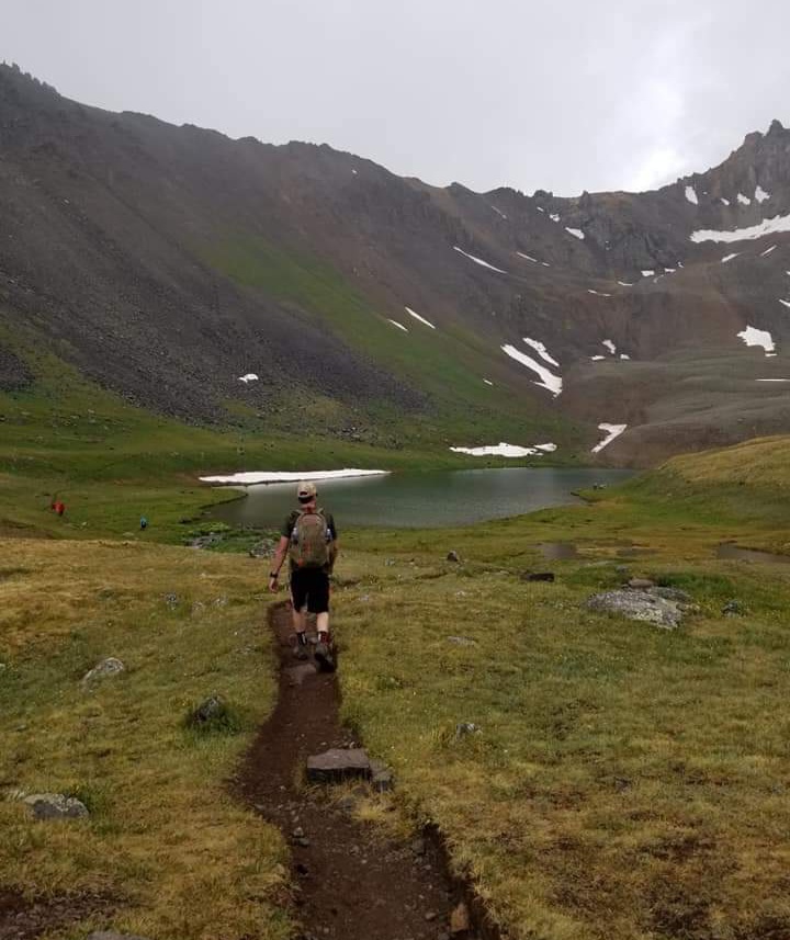 Man hiking to alpine lake