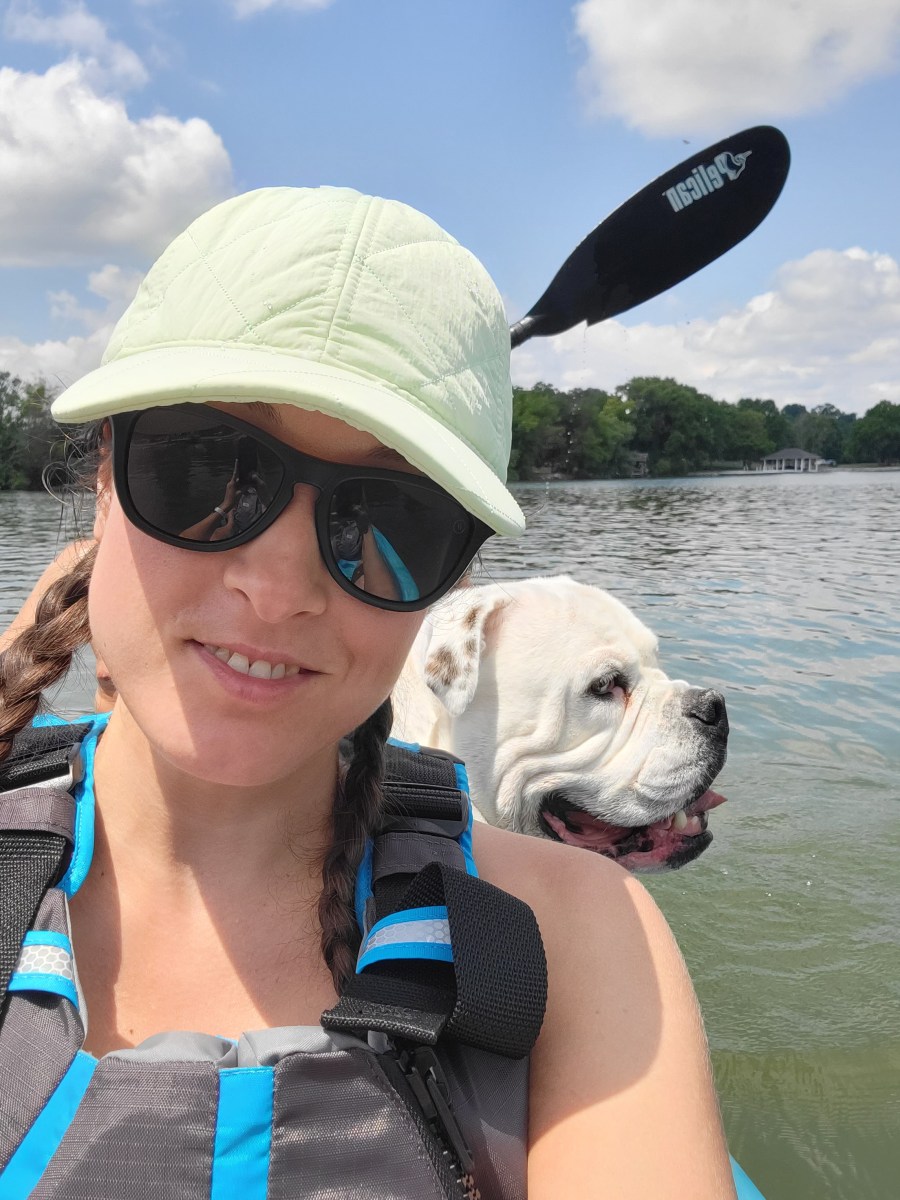 Woman and a dog on a kayak