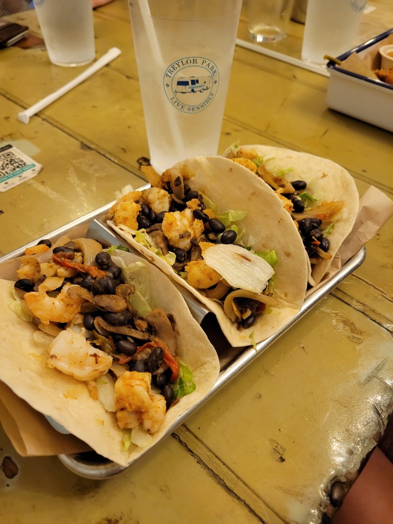 Tray of 3 fish tacos and cup of water