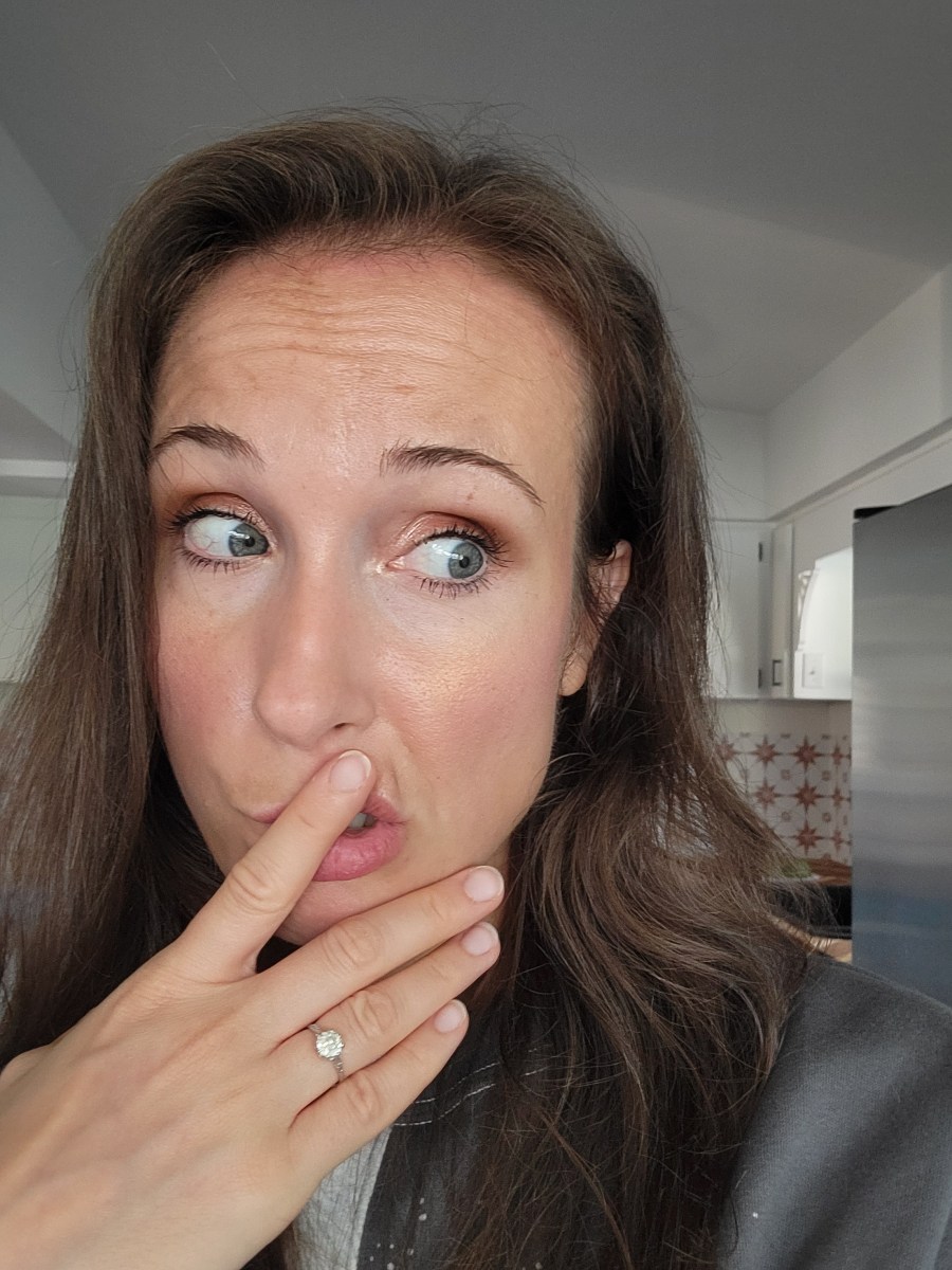 Woman with hand over mouth