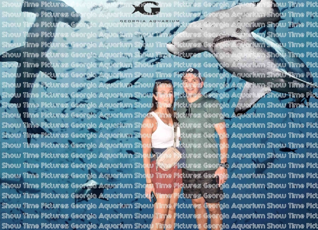 Woman and man standing in front of a shark greenscreen, with a watermark over the photo.
