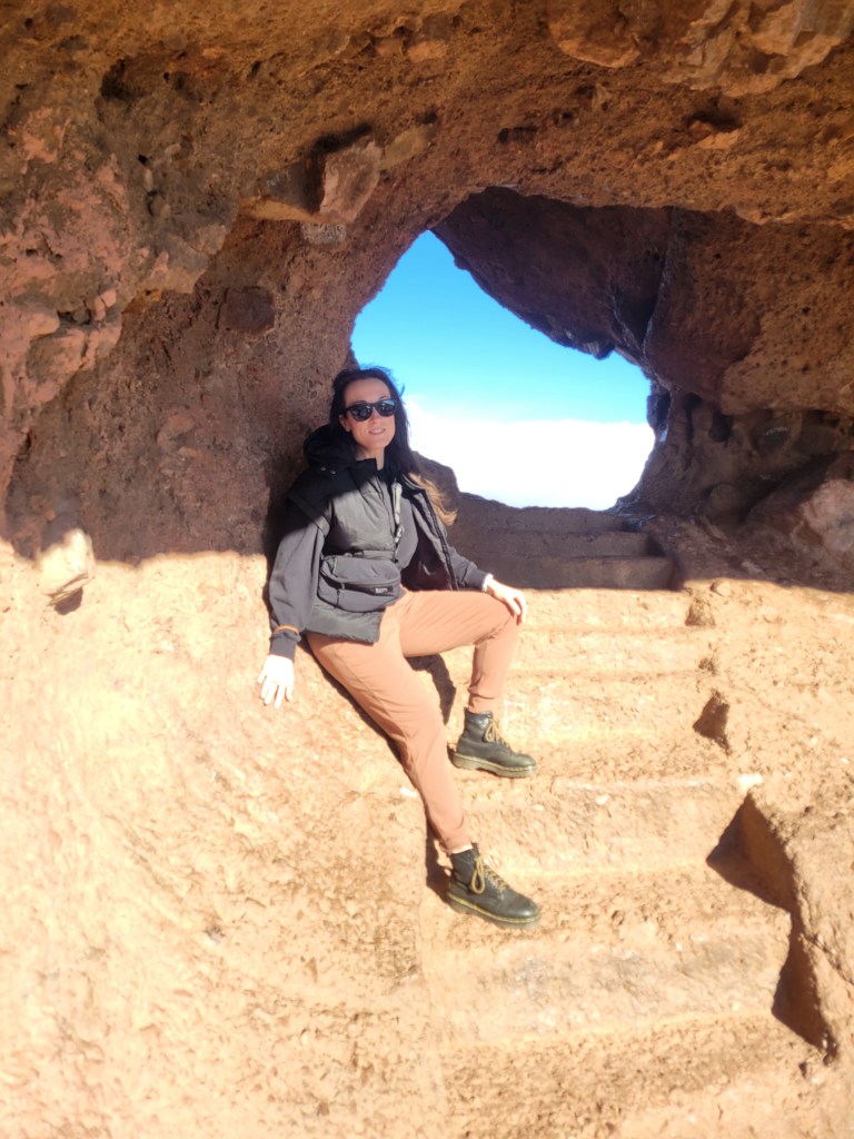 Women leaning against a stone stairway