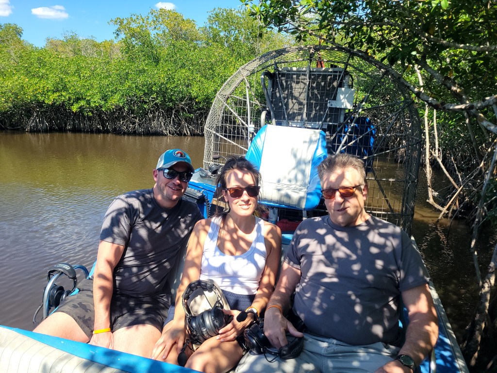 Three passengers on an airboat tour