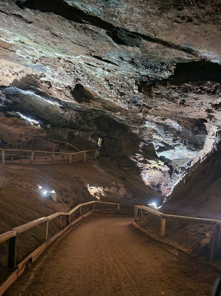 Dirt path with a railing inside a cave