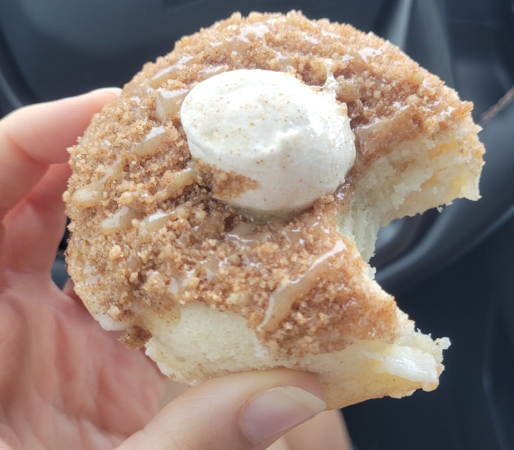 Vegan butterscotch churro donut with a bite eaten