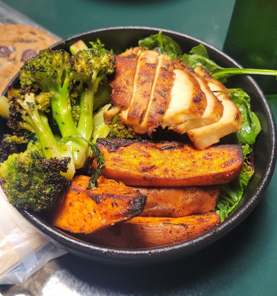 Bowl of grilled chicken, sweet potatoes, and roasted broccoli 