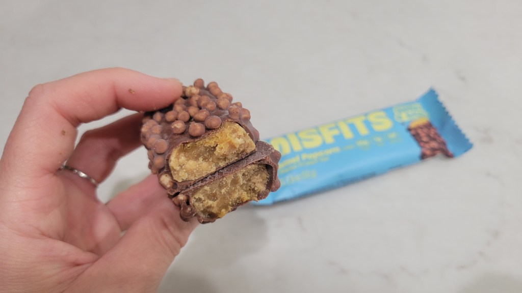 Misfits protein bar showing the inside of the bar with the wrapper in the background