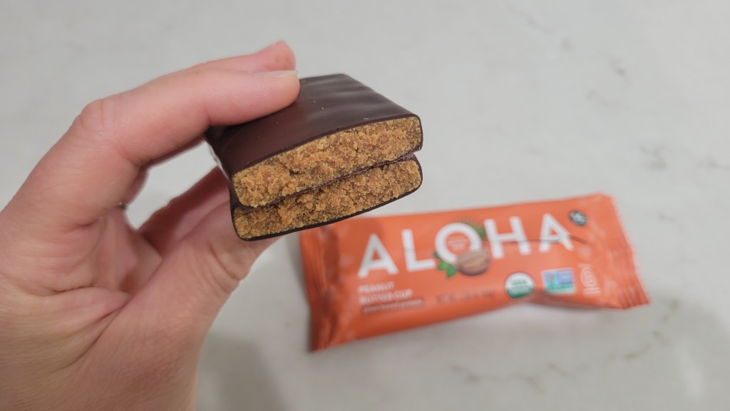 ALOHA peanut butter cup protein bar inside and outside of bar