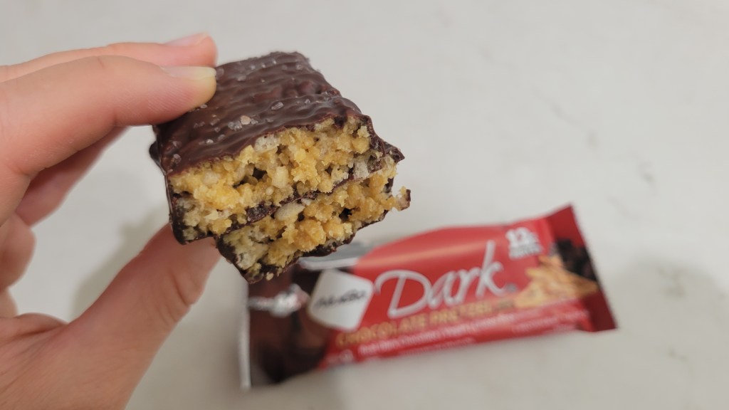 NuGo Dark Chocolate Pretzel protein bar inside snd outside of bar