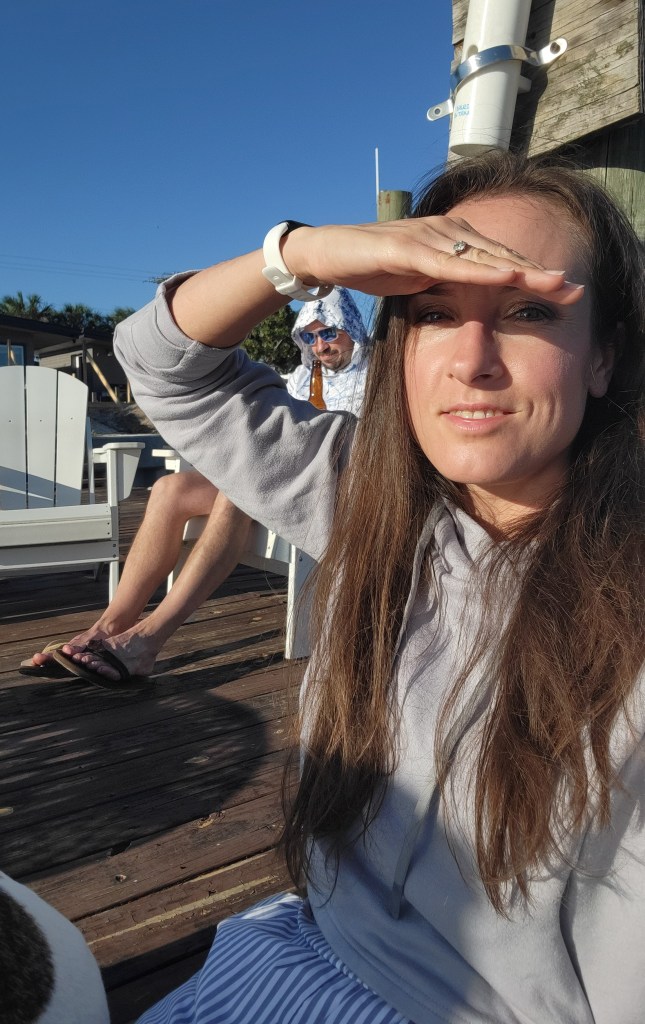Woman and man sitting on a dock