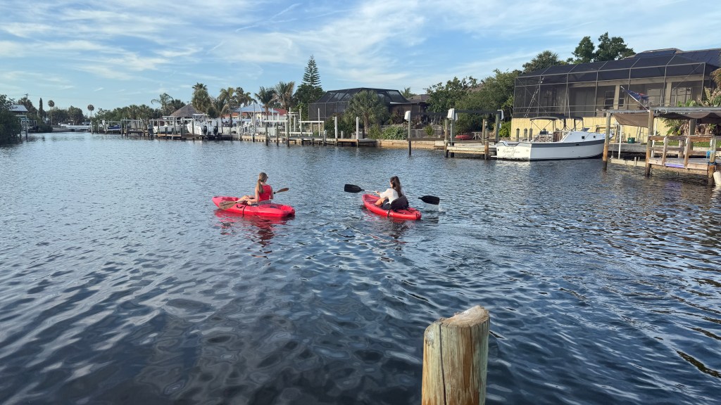 Two women kayaking in a canal