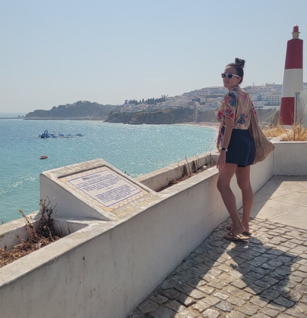 Woman looking out on a beach in Portugal