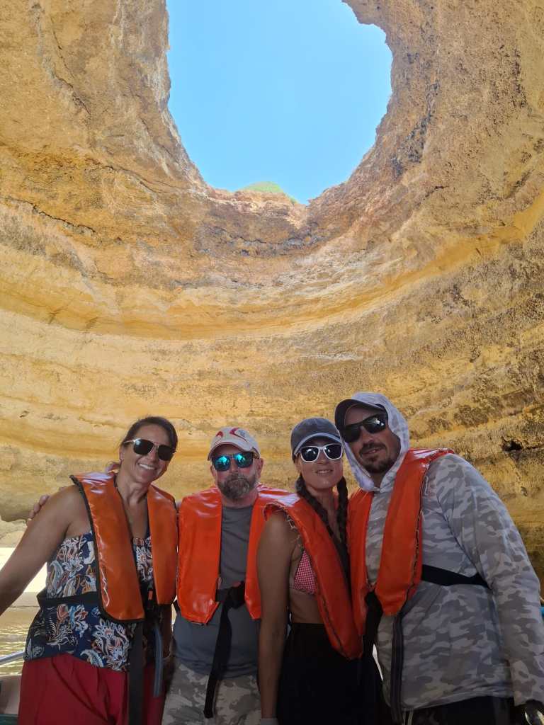 Four people in a cave on a boat in Portugal 