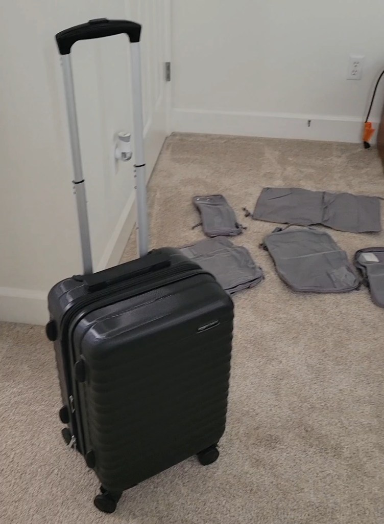 Black hard-shell suitcase and packing cubes