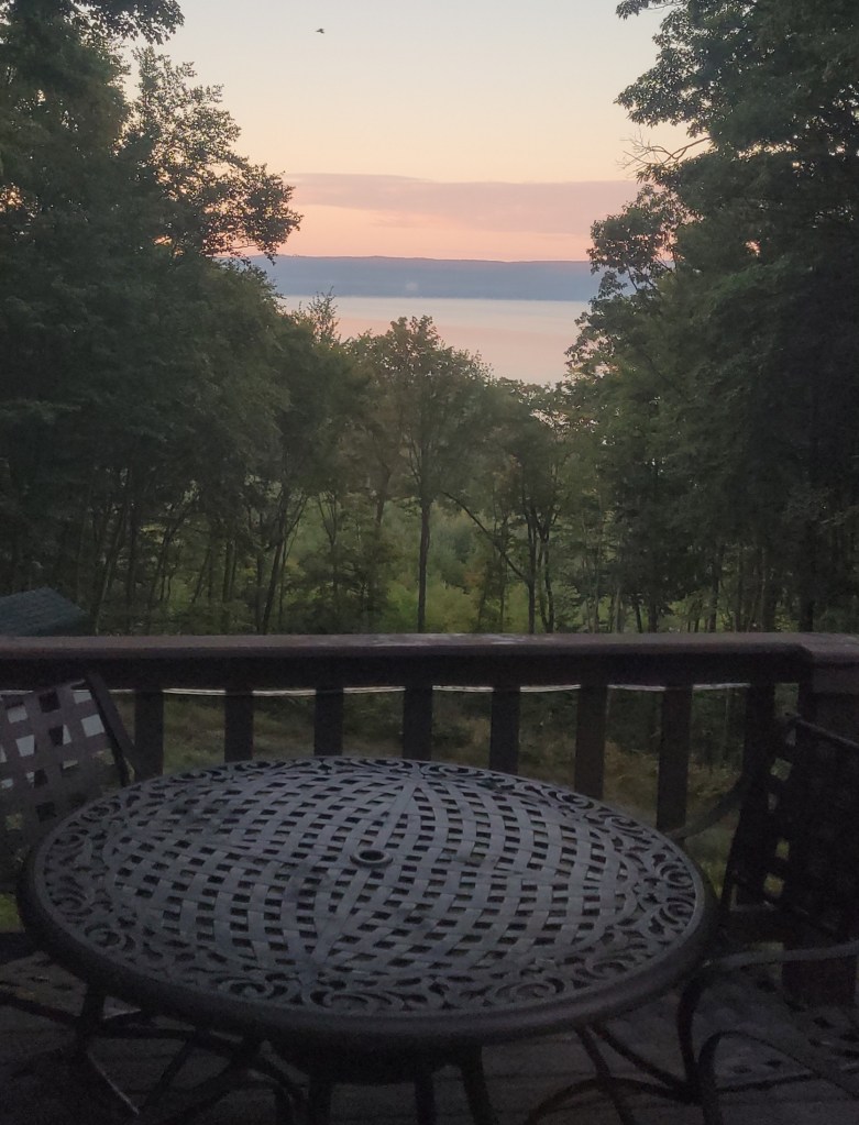 View from a balcony of a sunrise over a lake