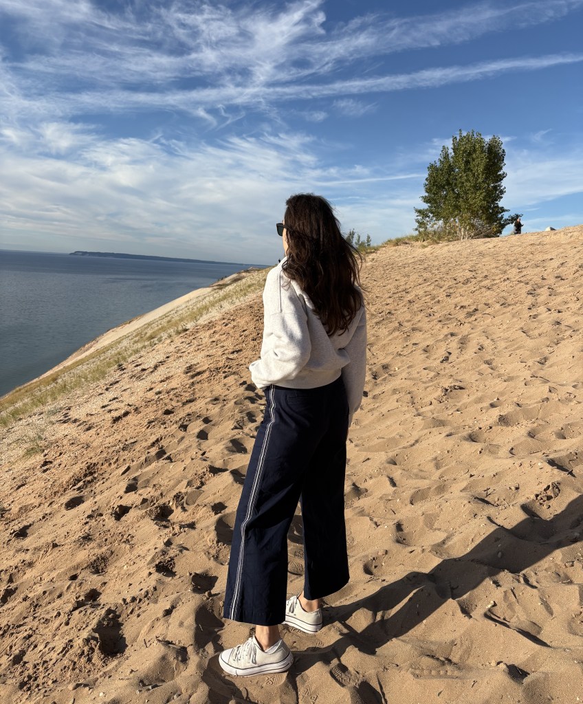 Woman standing on a dune at Sleeping Bear Dunes National Lakeshore in Michigan 